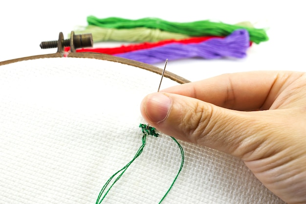 ręce haftujące materiał
